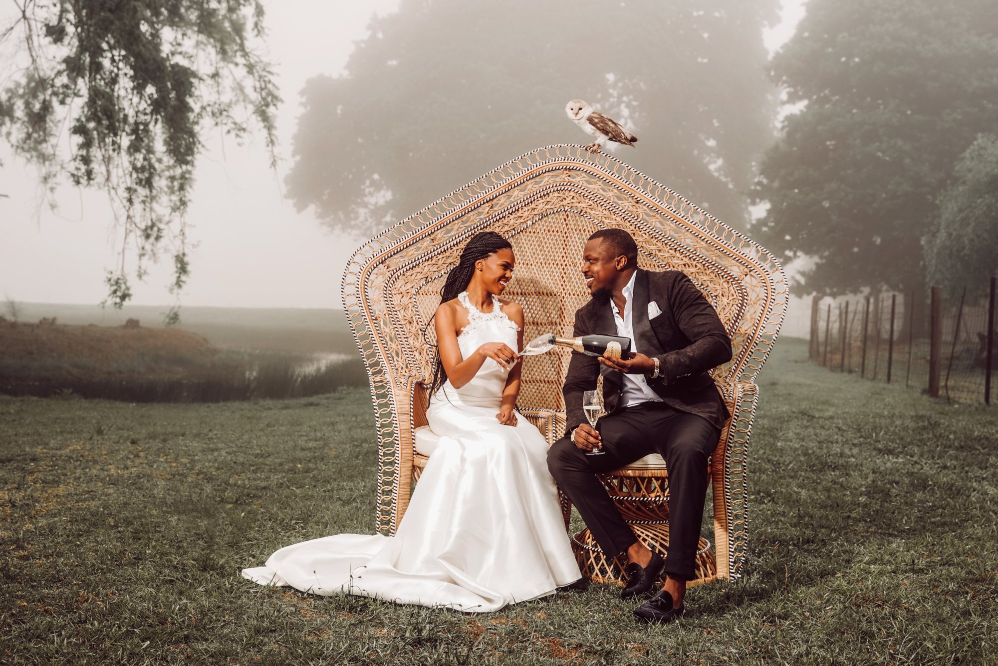 Couple seated on a Peacock Pose Emperor Chair outdoors