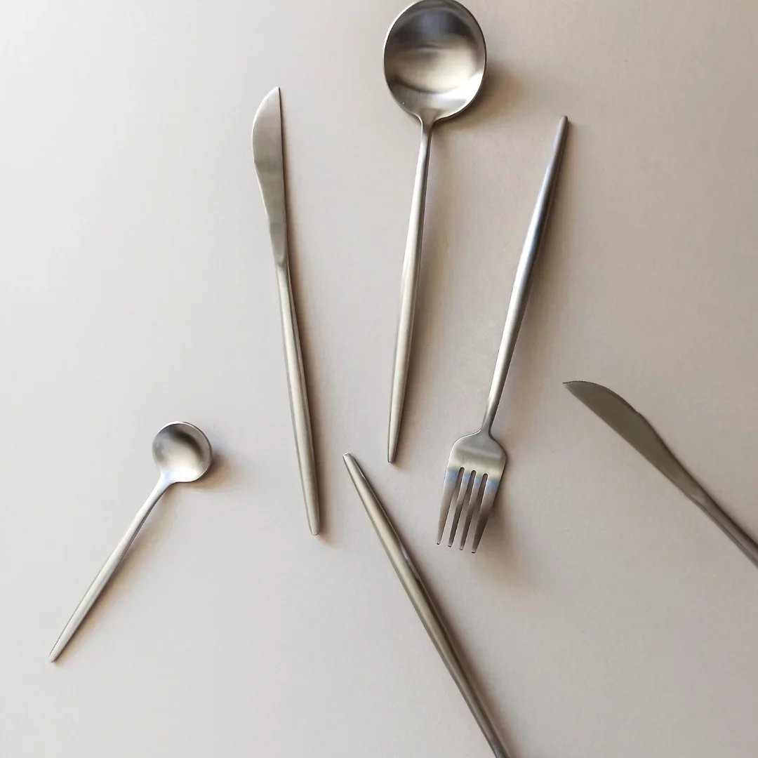 Set of stainless steel cutlery including knife, fork, and spoons