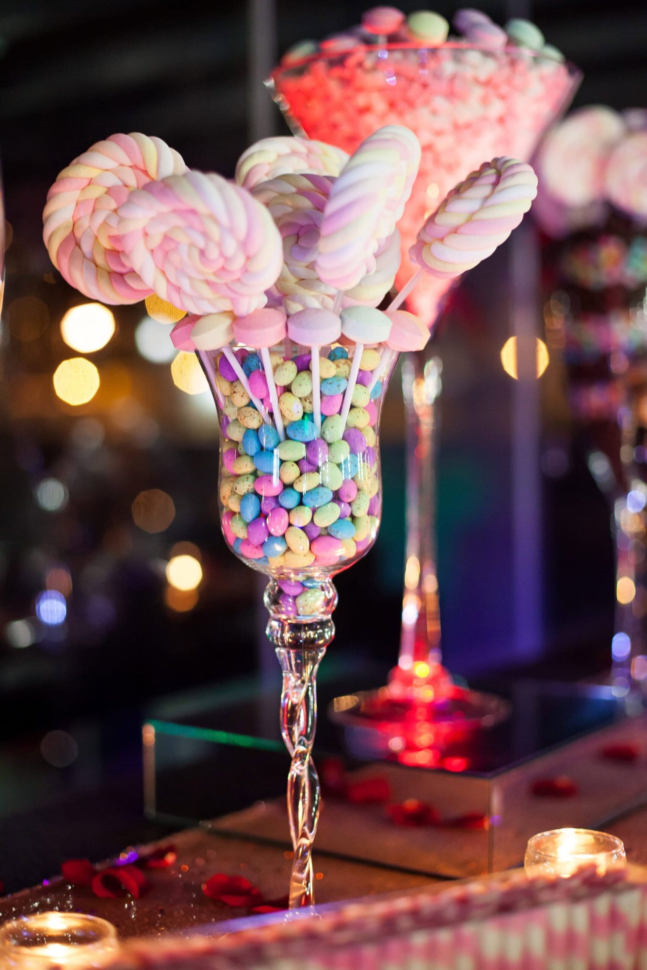 Candy display with lollipops and colorful chocolates.