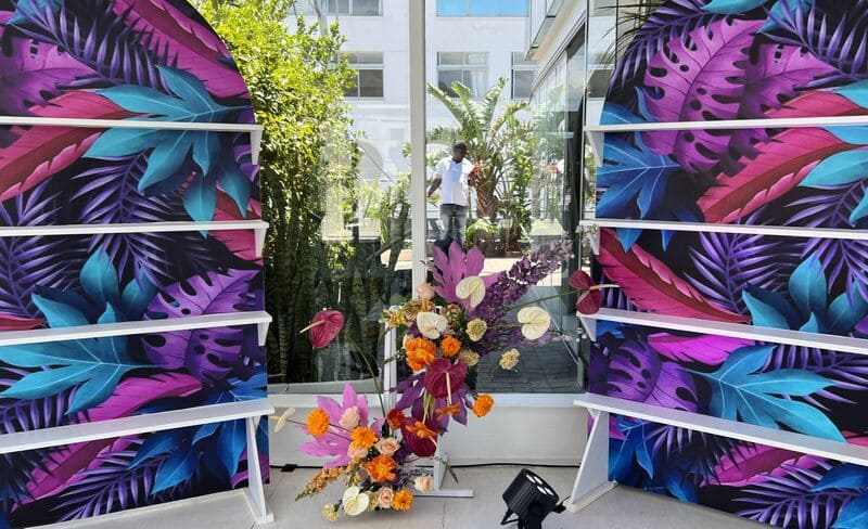 Tropical backdrop with colorful foliage and floral arrangement