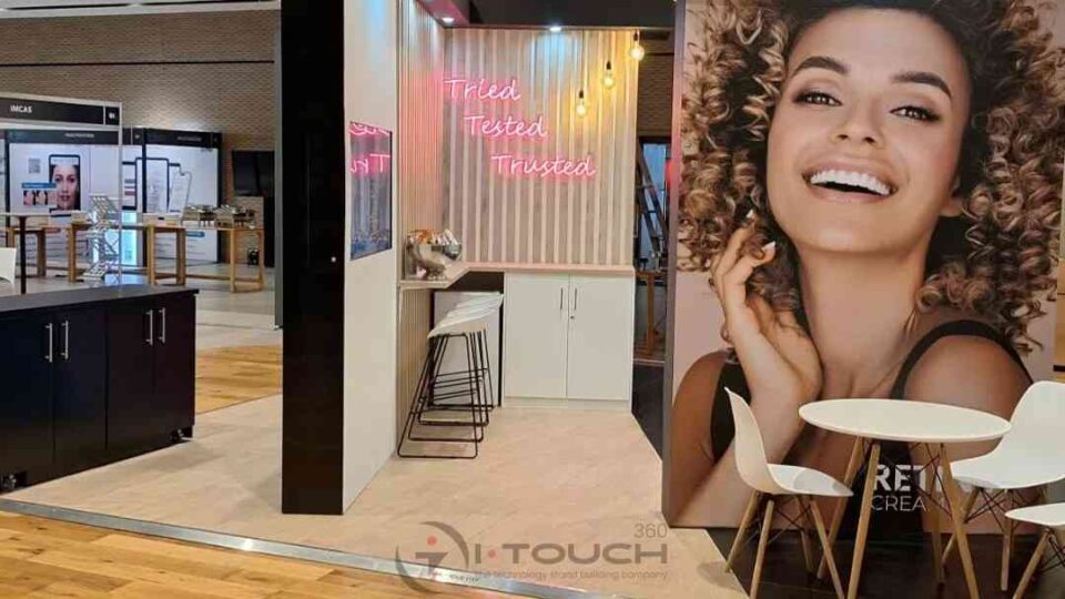Custom exhibition stand with branding and seating area.