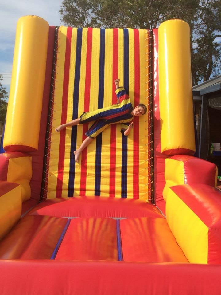 Child enjoying the inflatable bungee jump attraction.