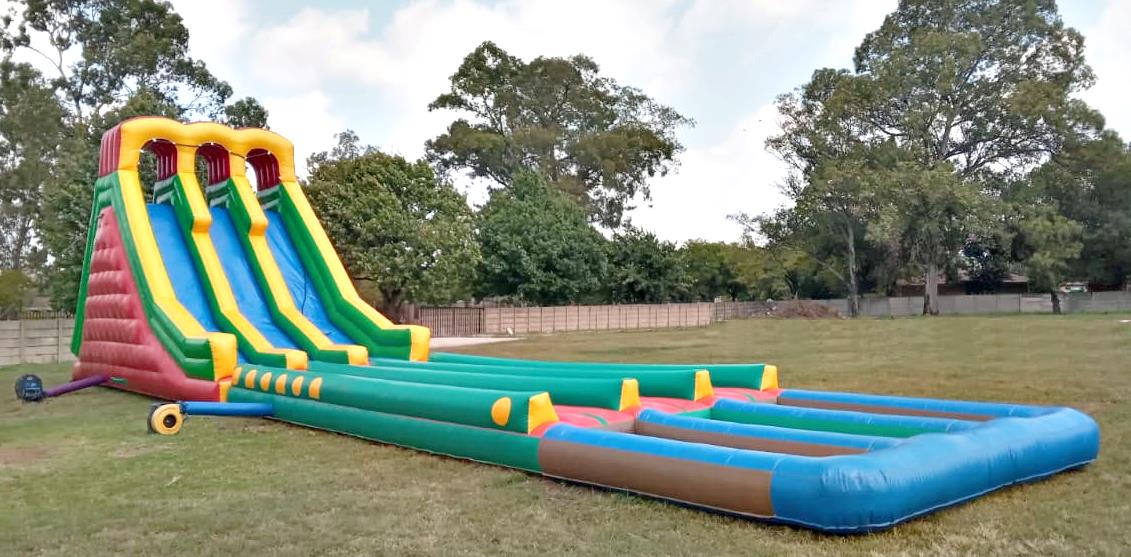 A large inflatable water slide set up on grass