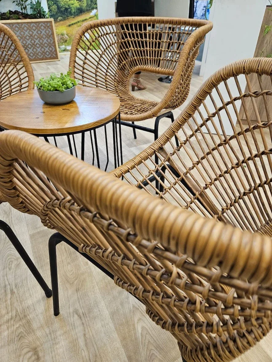 Rattan seating and wooden table arrangement