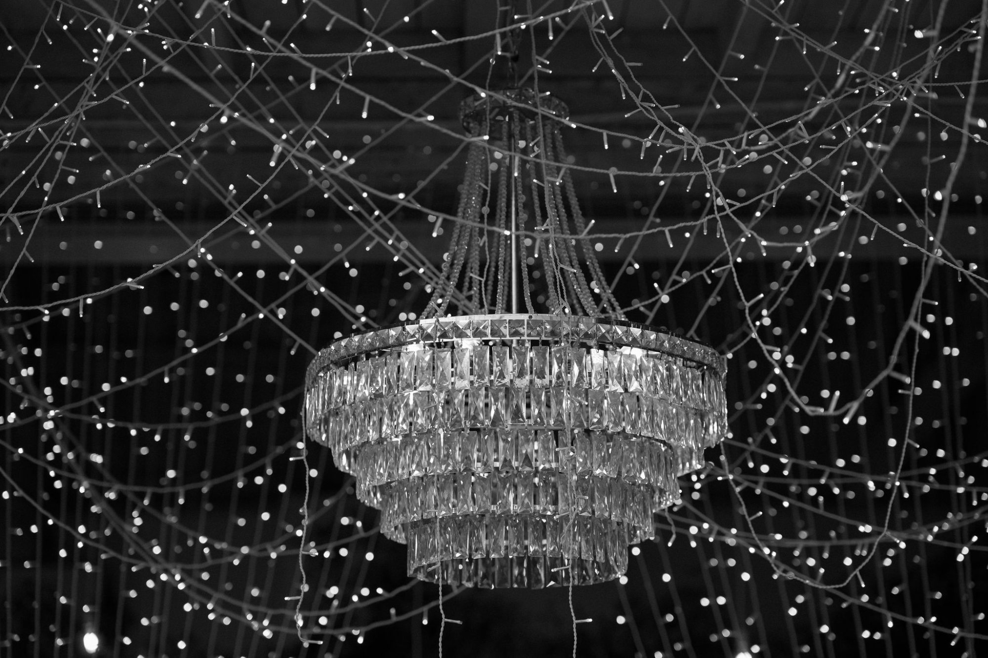 A classic chandelier surrounded by twinkling fairy lights.