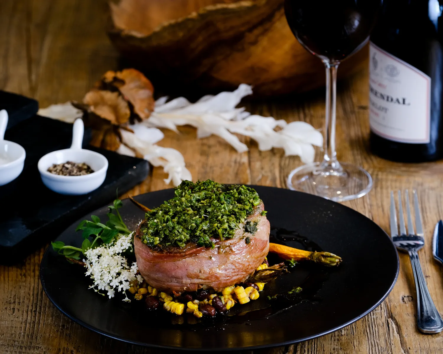 Plated gourmet meat dish with herbs and vegetables