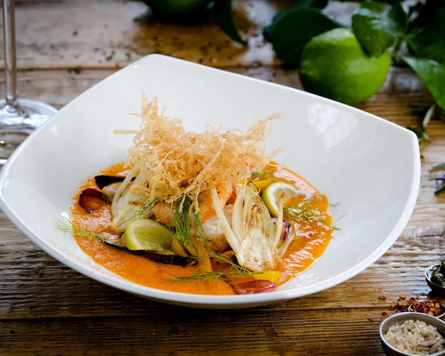 Gourmet dish in white bowl with sauce and garnishes