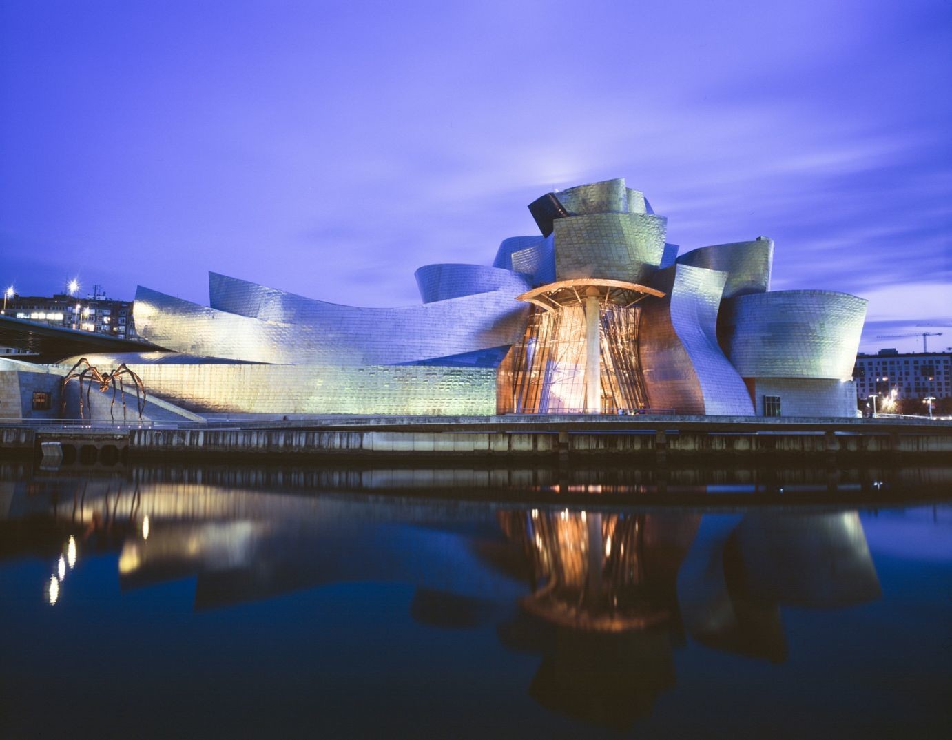 Renowned architectural venue by a body of water at dusk