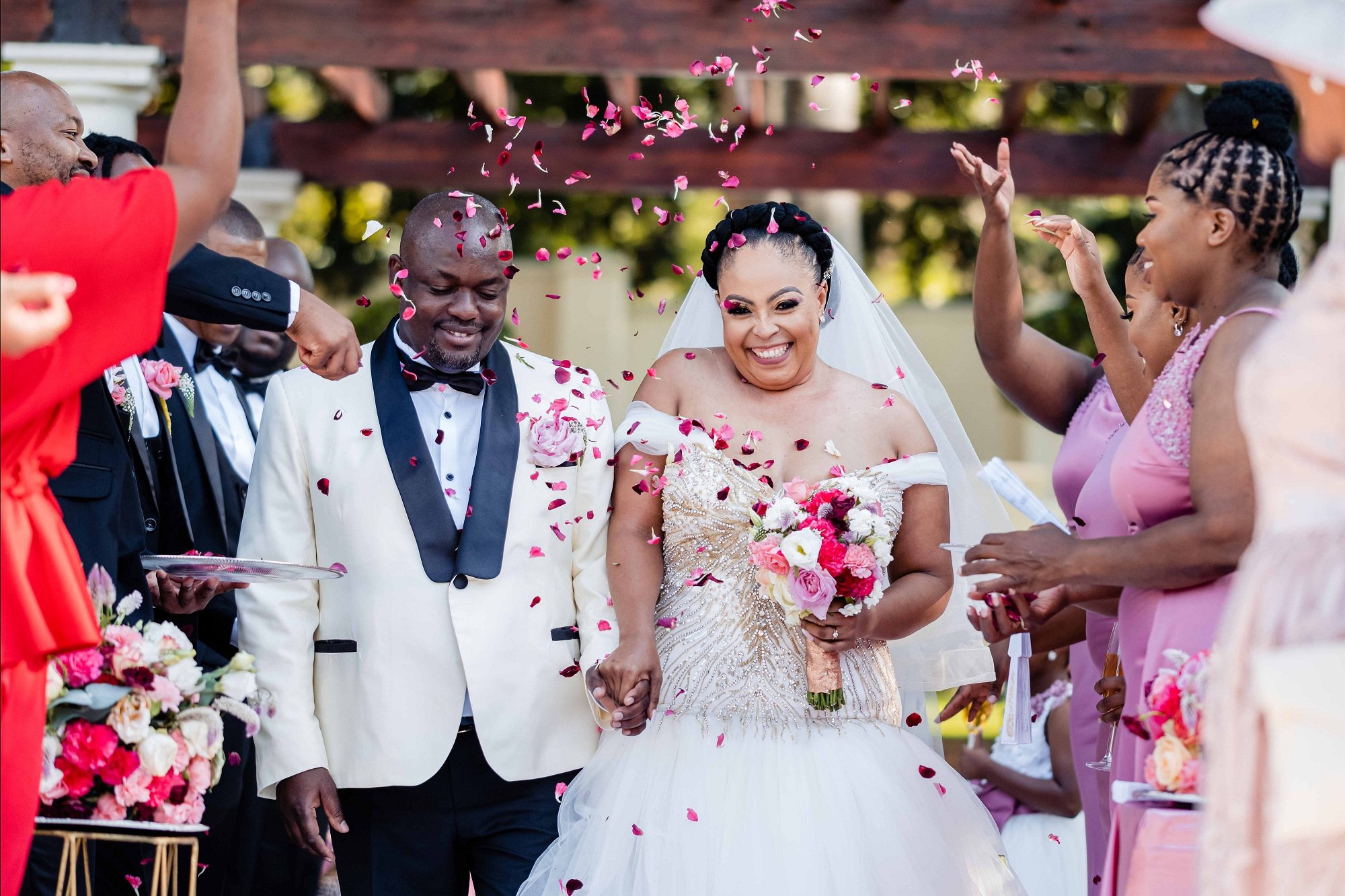 Couple celebrating wedding with confetti and flowers