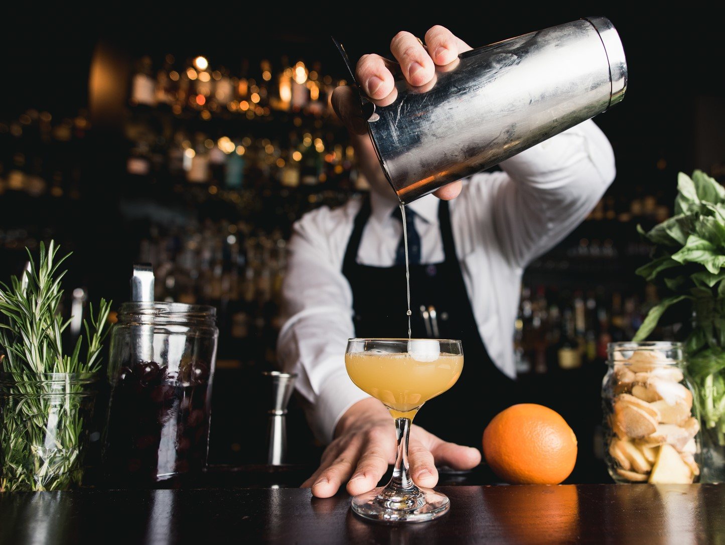Bartender shaking a cocktail in a bar setting