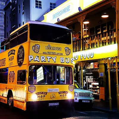 Yellow party bus parked outside Beerhouse in Johannesburg