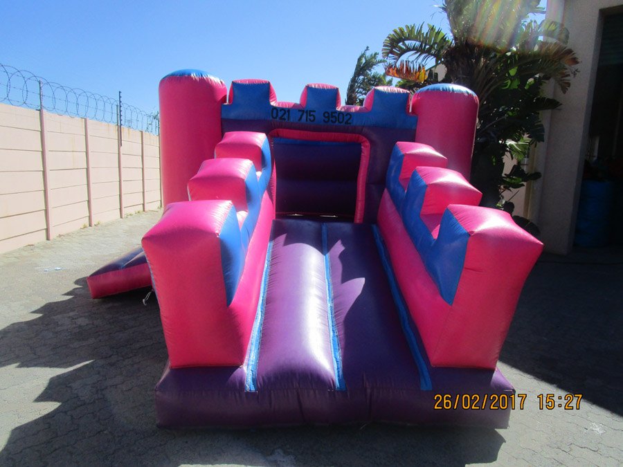 Pink and blue jumping castle setup in Ottery