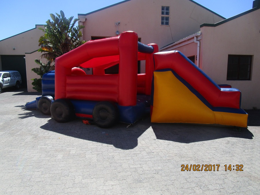 Truck-themed inflatable jumping castle with slide