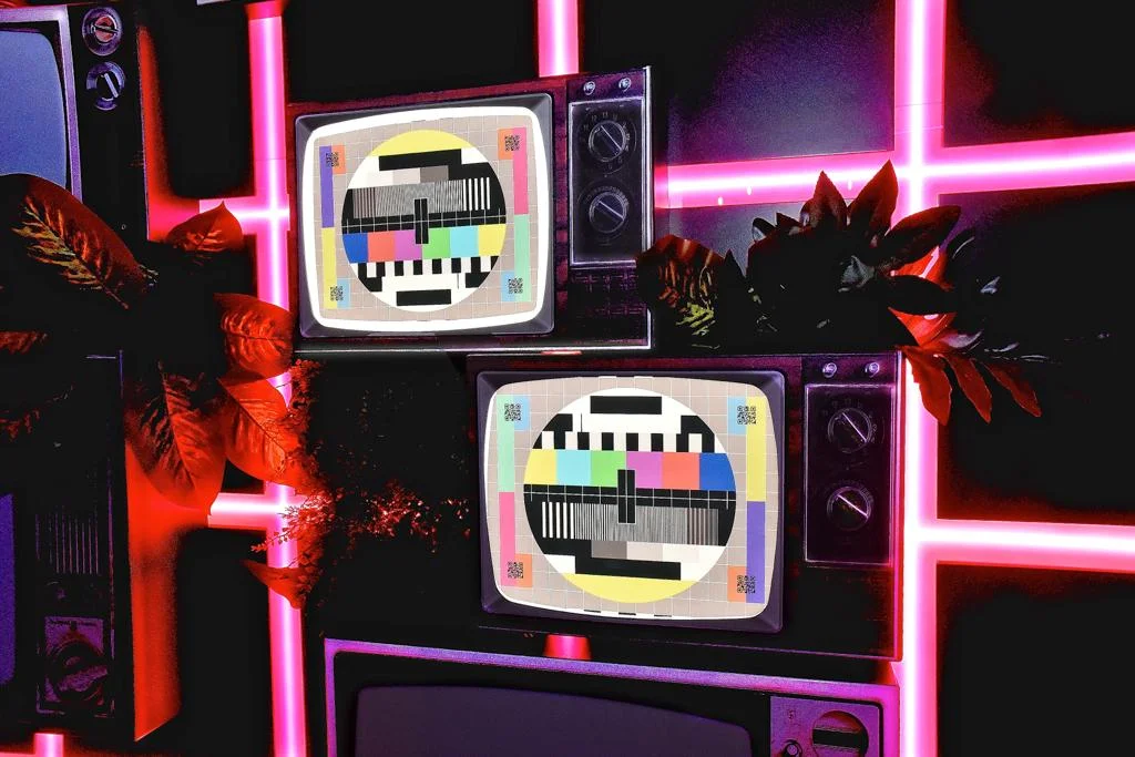 Retro TVs with colorful test patterns against a neon backdrop