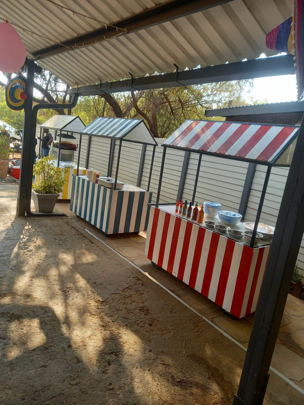 Colorful striped food stalls arranged for an outdoor event