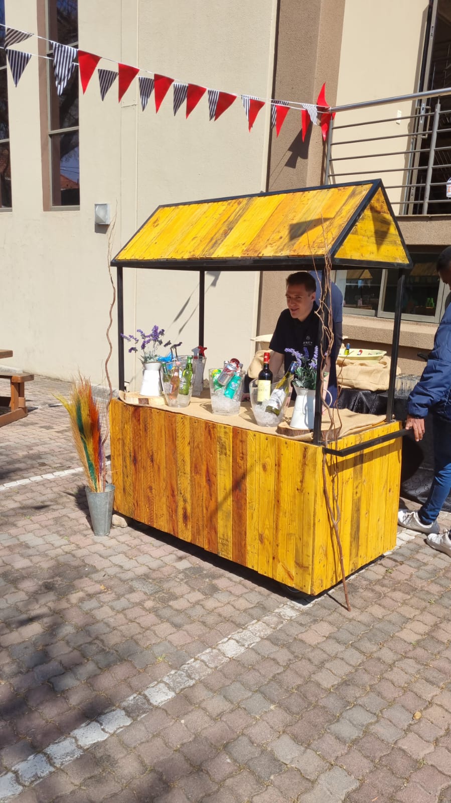Wooden refreshment cart with drinks and decorations