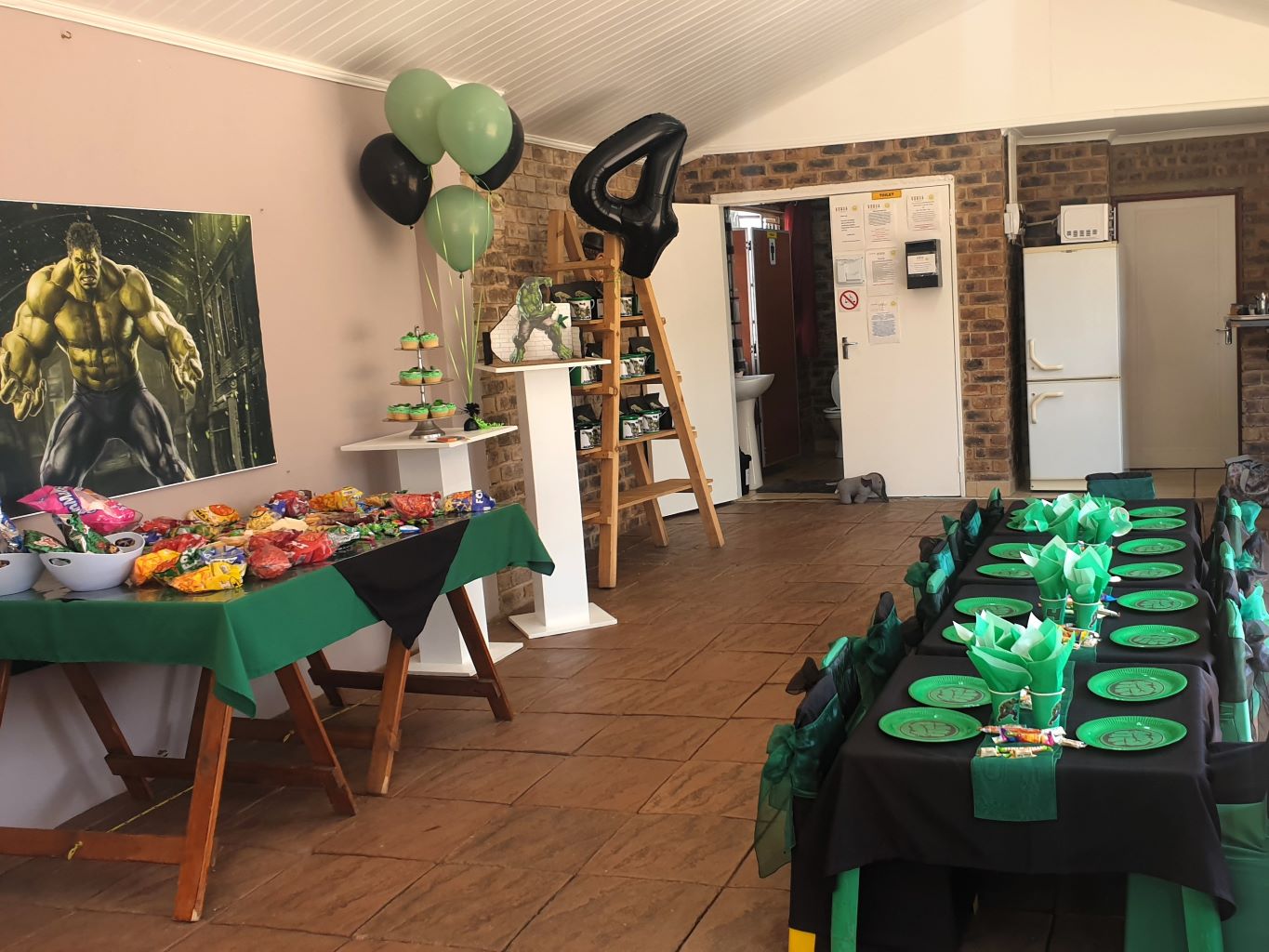 Themed kids party setup with tables, snacks, and decorations.