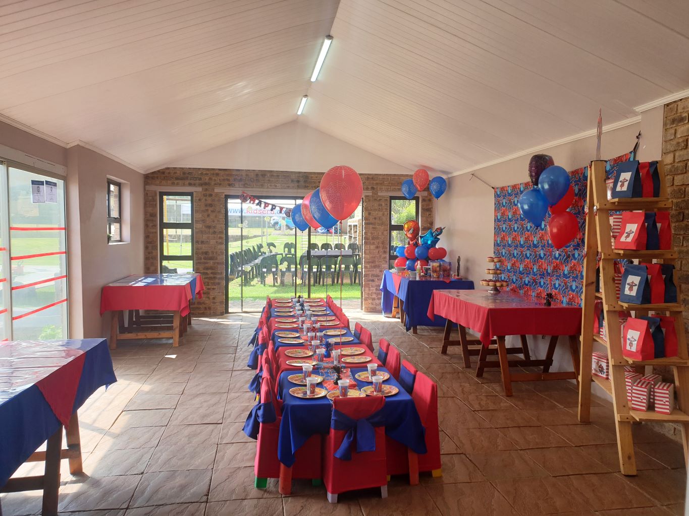Colorful party decorations and table settings for a children's event.