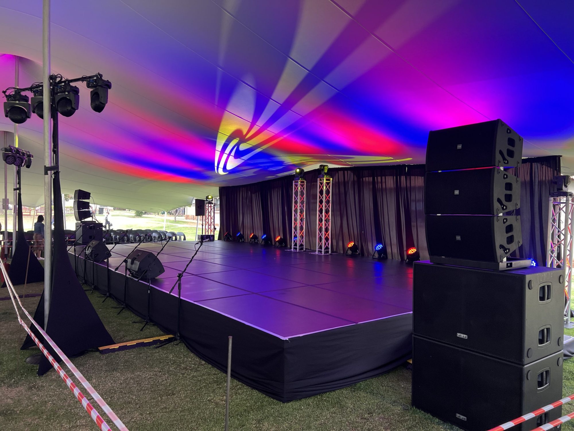 Outdoor stage with sound speakers and colourful lighting effects