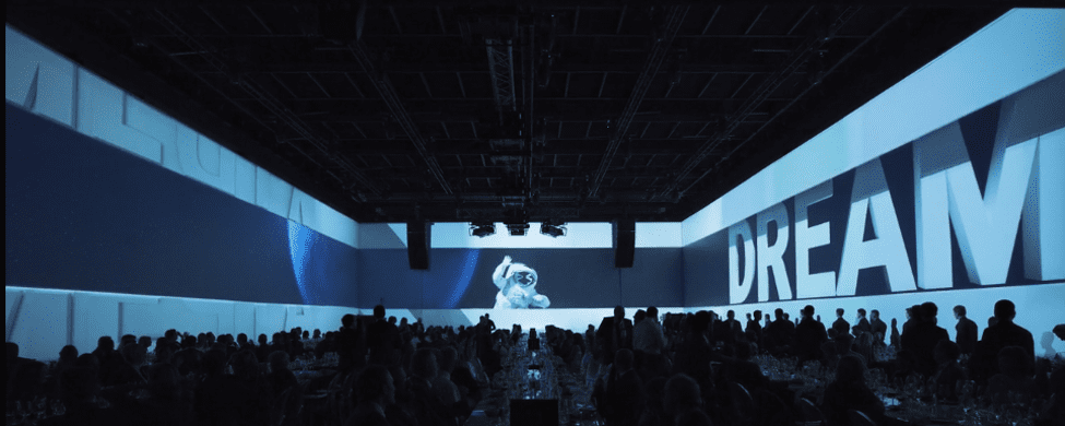 Projection mapping display on venue walls with audience