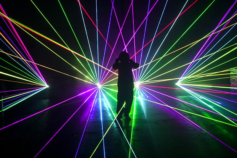 Colorful laser beams illuminating a dark space