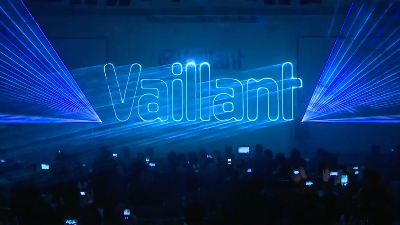 Laser projection showcasing 'Vaillant' with blue beams in a dark venue.