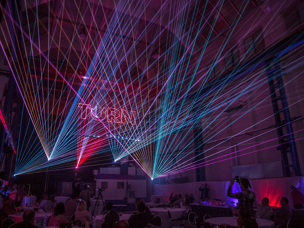 Colorful laser beams creating a dynamic display in an event space