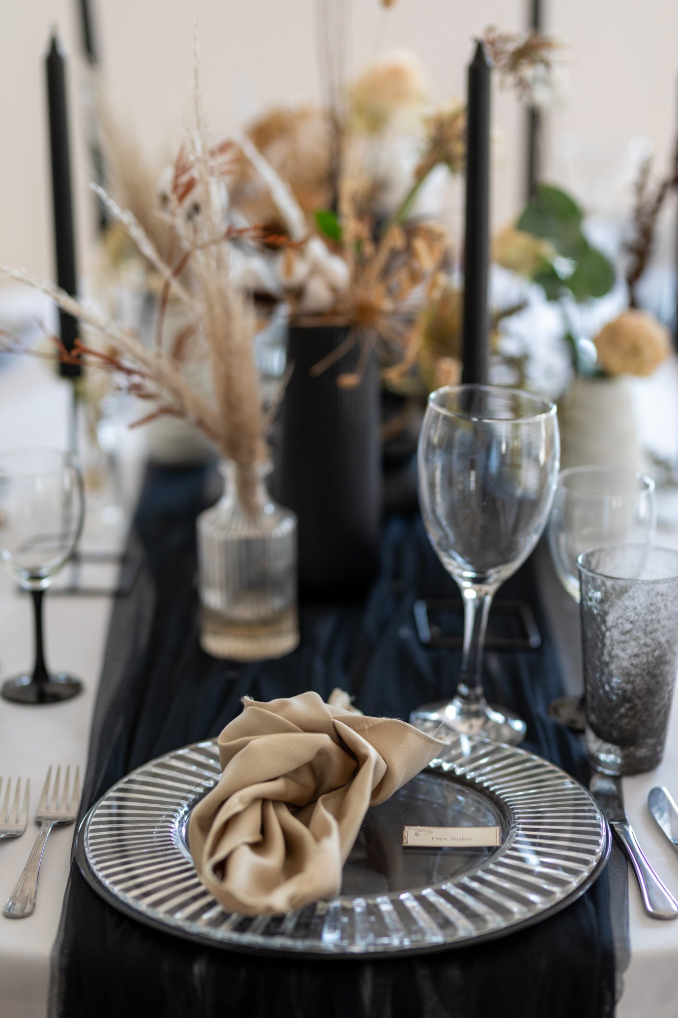 Elegant table setting with glassware, napkin, and decor