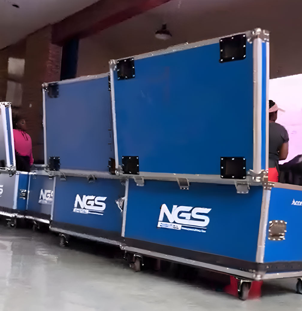 Stacked blue transport cases with NGS logo