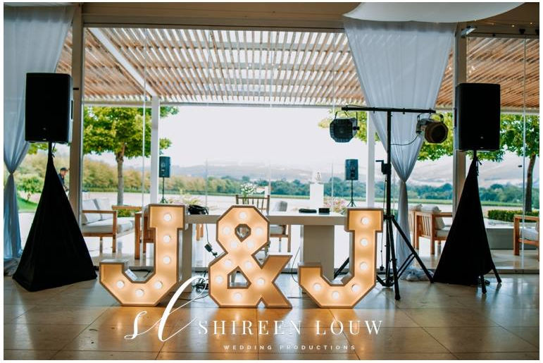 Large J and J illuminated marquee letters indoors