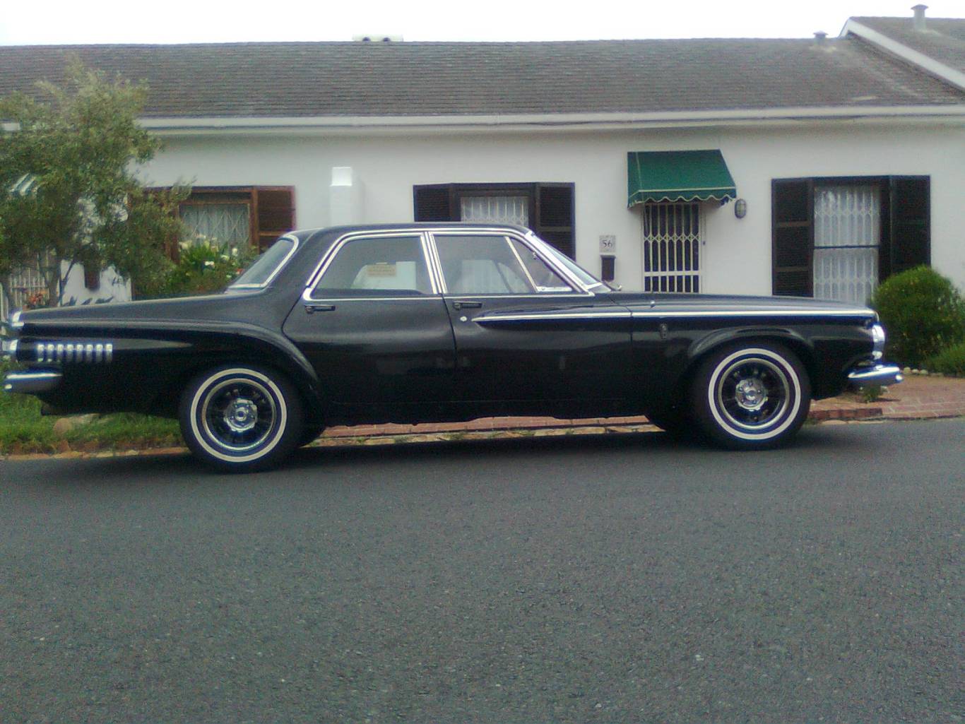 Black classic car parked on a residential street