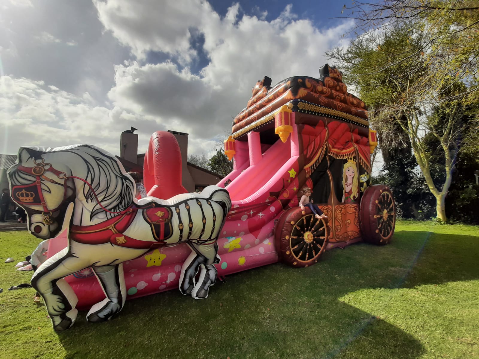 Princess carriage themed jumping castle with horse and slide.