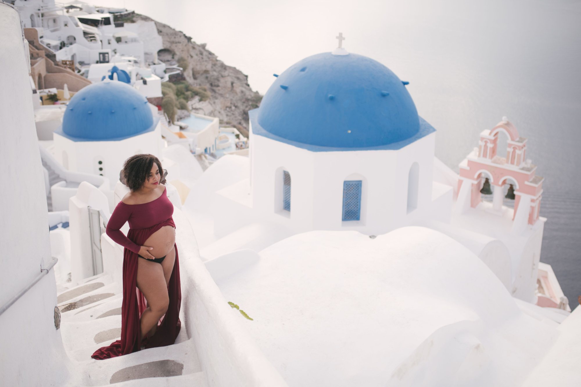 Expectant mother in a flowing dress at a scenic location