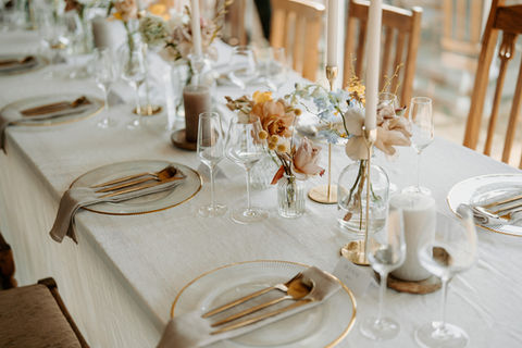 Elegant table setting with floral arrangements and glassware