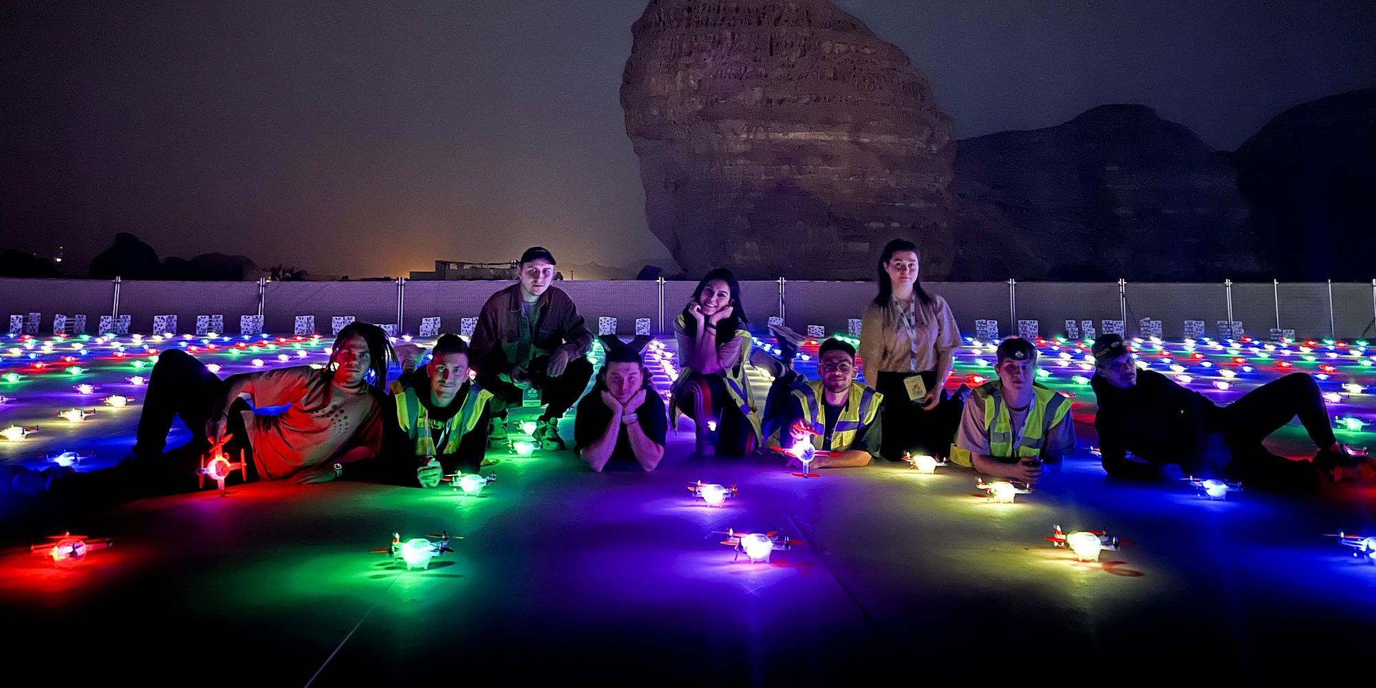 Lumasky Drone Show team preparing drones on a rooftop at night.