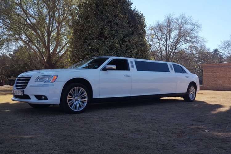 White Chrysler 300 C Limousine parked on grass