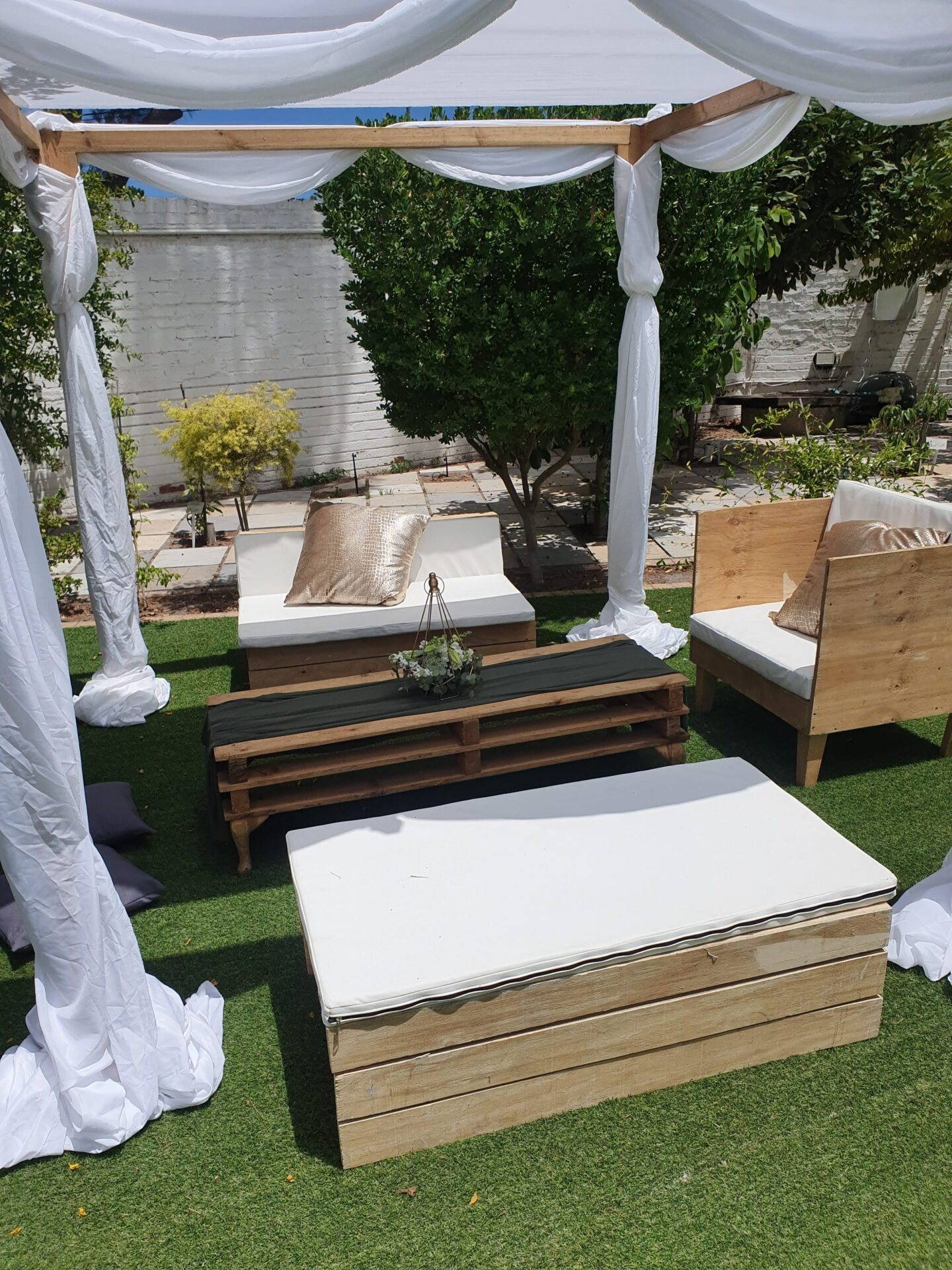 Outdoor lounge seating with cushions and wooden tables