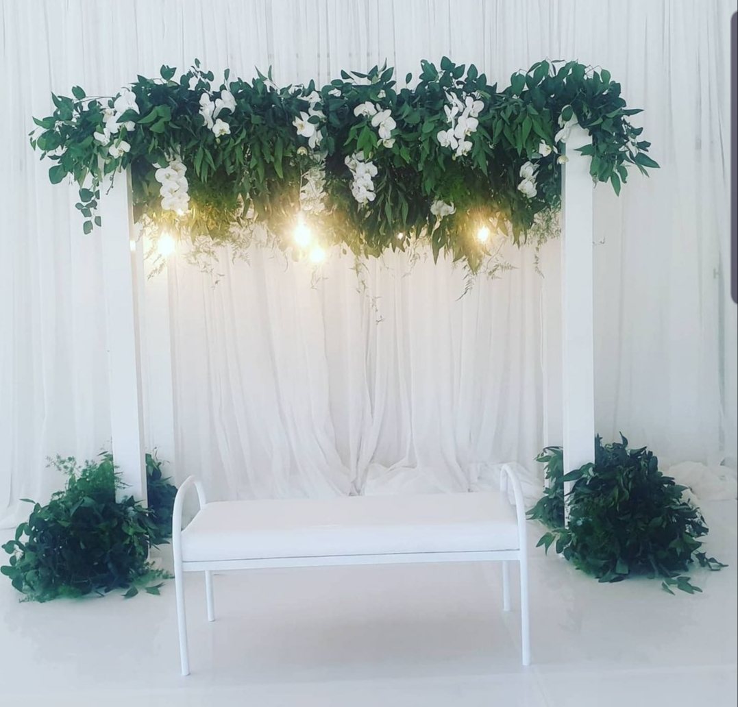 Floral arch with white flowers and greenery