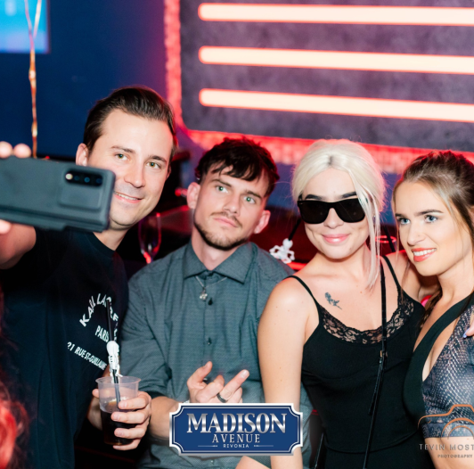 Group of friends smiling and taking a selfie at Madison Avenue Rivonia.