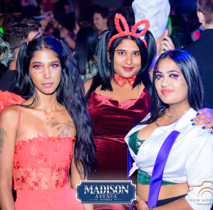 Three women in themed party outfits at Madison Avenue Rivonia.