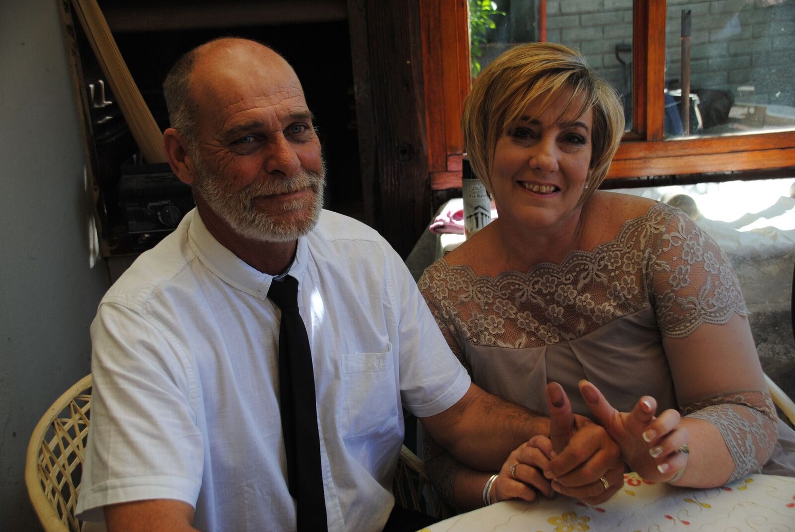 Couple smiling at a wedding ceremony setup