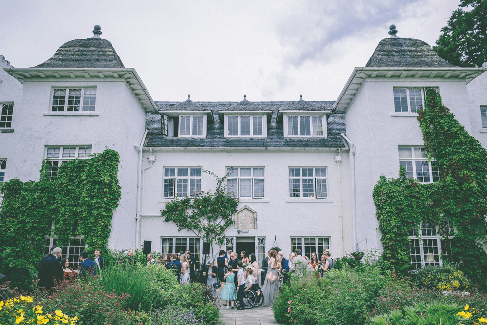 An elegant wedding venue surrounded by greenery and flowers.