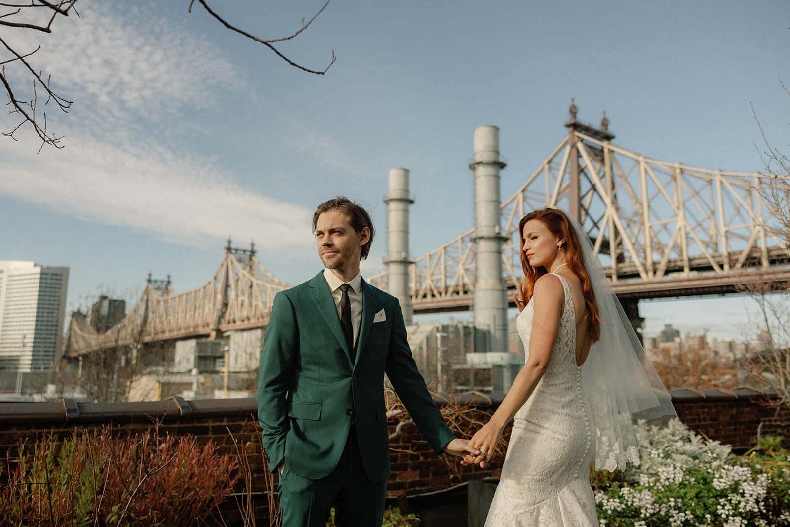 A couple holding hands with a city skyline in the background.