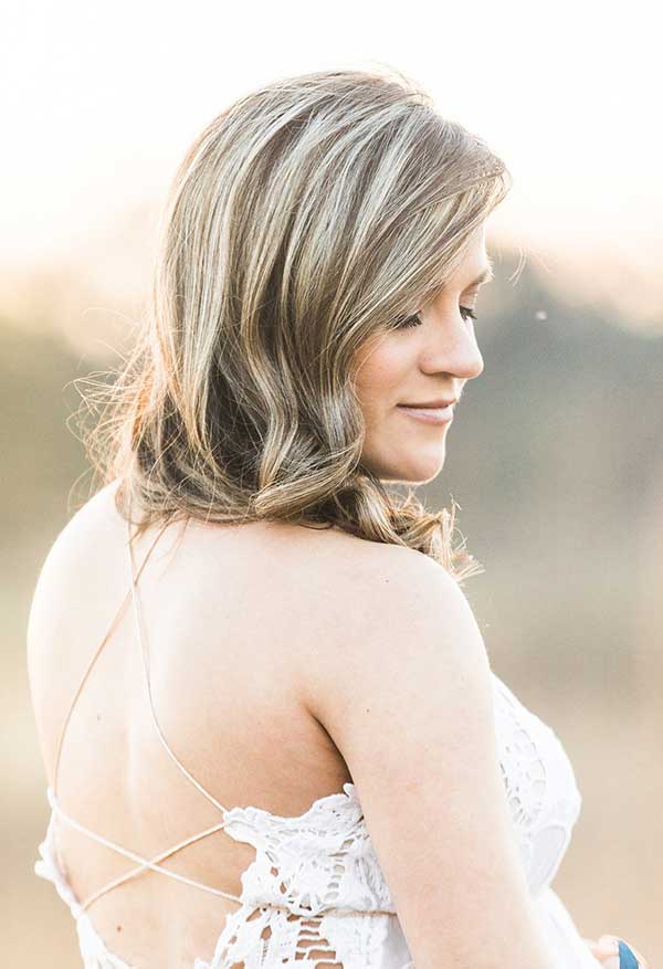 Bride with natural makeup and lace dress outdoors
