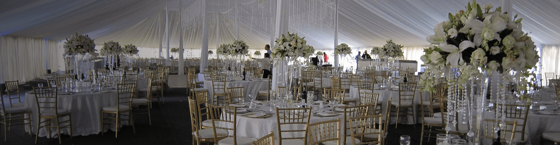 Elegant banquet setup with round tables and floral centerpieces.