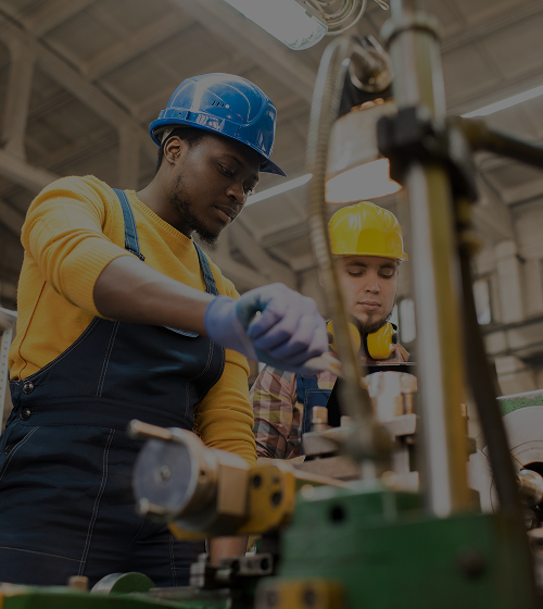 Two technicians working on gas handling equipment in a facility.
