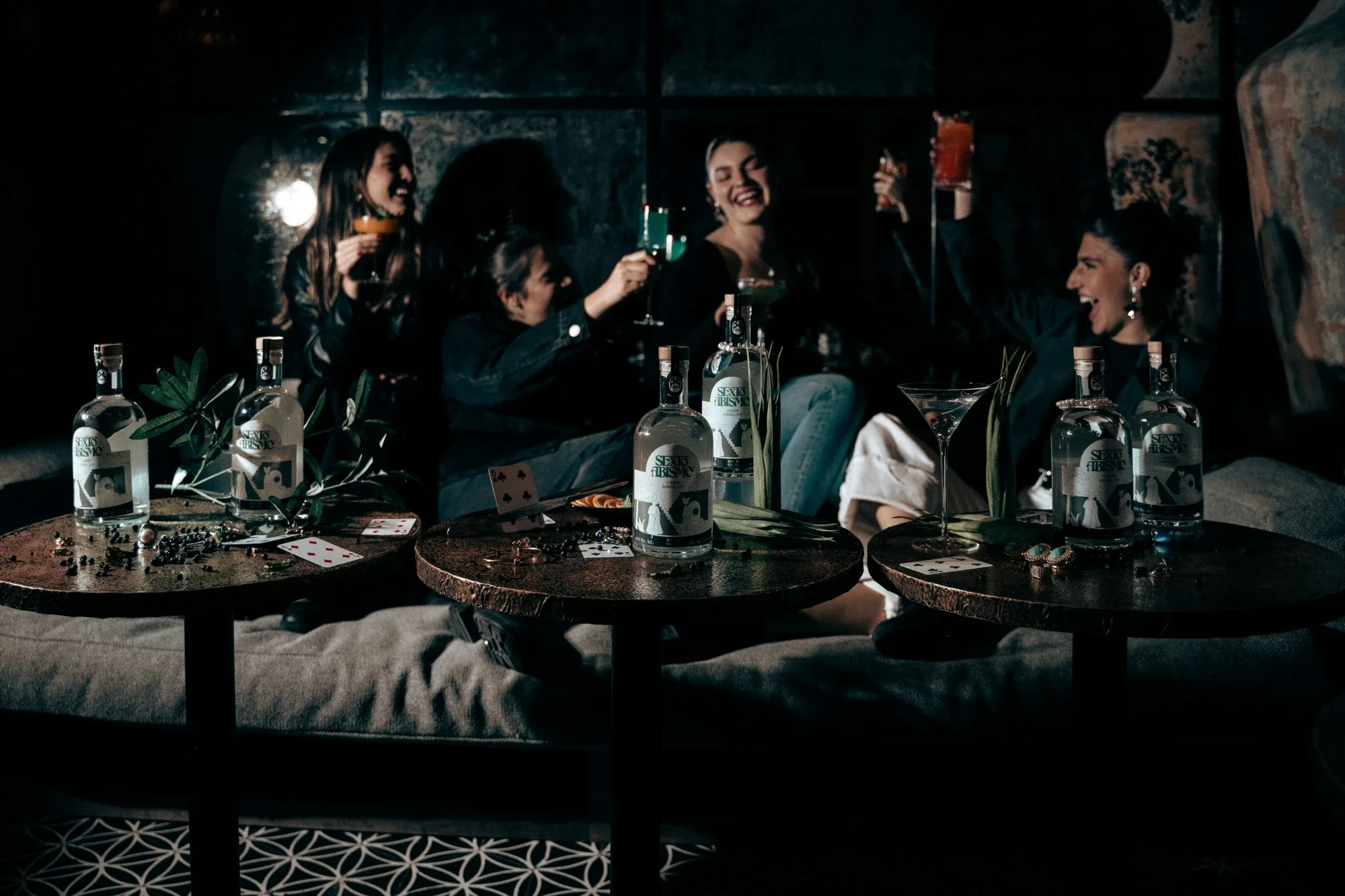 Group of people toasting with cocktails during a murder mystery event.