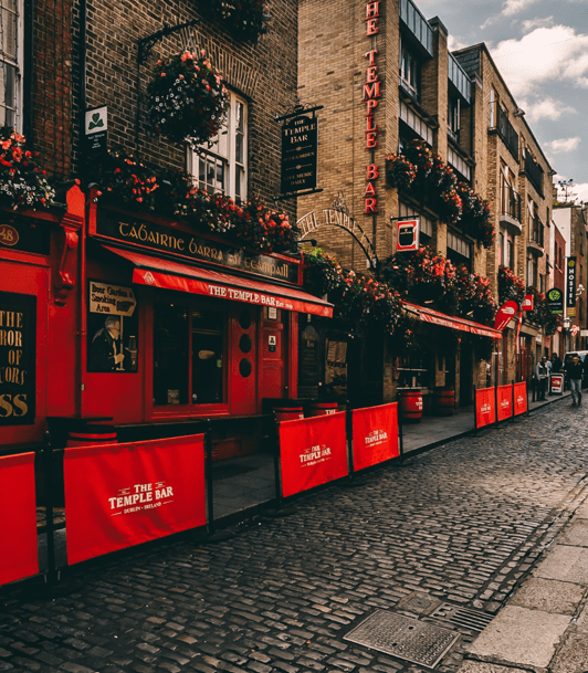 Outdoor venue setup with red barriers and flowers at The Temple Bar