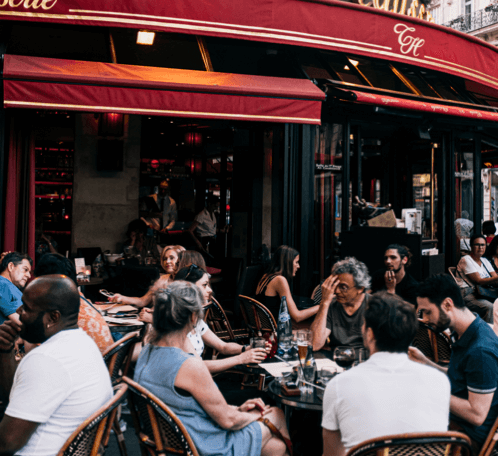 Group of people sitting at a café engaged in conversation.