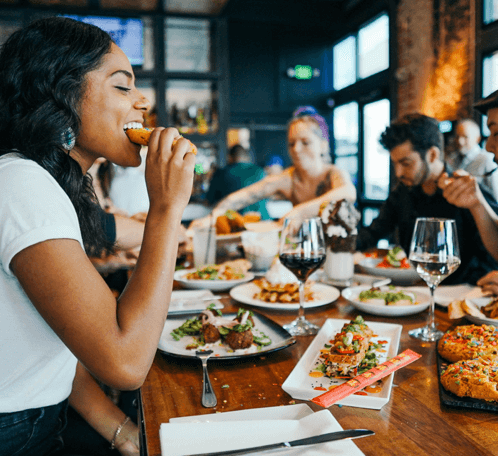 Group of friends enjoying a meal at a party setting.
